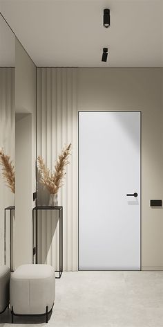 an empty room with a white door and two stools in front of the door