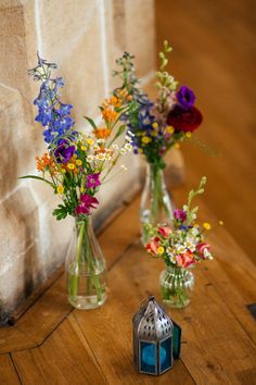 three vases filled with different types of flowers