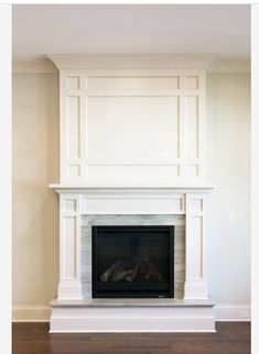 an empty fireplace with white paint on the mantle