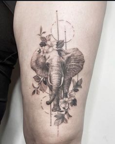 an elephant with flowers on it's thigh