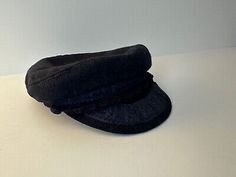 a black hat sitting on top of a white table