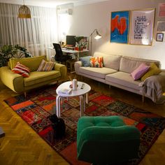 a living room with two couches and a rug in front of the window,