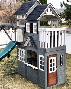 a play house with a slide in the yard