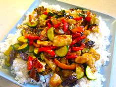 a white plate topped with rice and veggies