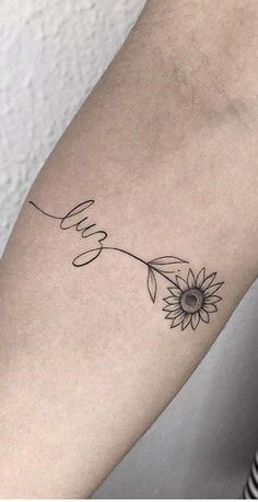 a woman's arm with a sunflower tattoo on the left side of her arm