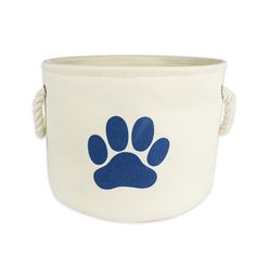 a white canvas basket with blue paw print on the side and rope handles for storage