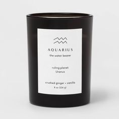 a black candle that is sitting on a white surface with the words capricorn printed on it