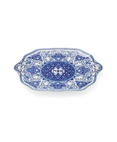 a blue and white tray with an intricate design on the bottom, in front of a white background