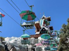 an amusement park with lots of chairs and umbrellas on the top of it's structure