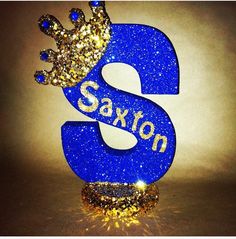 a blue and gold glittered number with the letter s on it