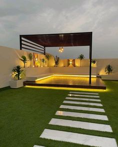 an outdoor area with grass and steps lit up by lights on either side of the walkway