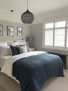 a bedroom with a large bed and pictures on the wall