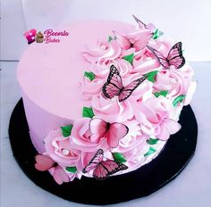 there is a pink cake with butterflies on it