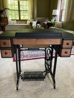 an antique sewing table in the middle of a living room