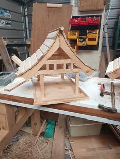 a wooden structure is being built in a workshop