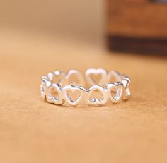 Silver Adjustable Heart Ring Perfect gift for someone special or yourself. Features: -925 silver stamped ring -Adjustable -Heart Height approximately 4mm Silver Maintenace: -Avoid direct contact with perfume and water -Clean with a soft clothe -Keep away from chemicals Follow us on FB and IG for new releases and give aways. Checkout our shop for similar items. Heart Eternity Ring, Heart Promise Rings, Heart Rings, Open Rings, Silver Heart Ring, Hollow Heart, Linking Rings, Silver Band Ring, Rings Jewelry