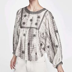 From Zara Comes This Embroidered And Embellished Boho Style Gray And White Tie Dye Blouse In Sz Small. In A Peasant Style Silhouette With 3/4 Balloon Sleeves, Dolman Style, Slightly Cropped Detail, Black Beading And Embroidered Detail Along Neckline And Yoke As Well As Sleeve Hems, Geometric Stitched Embroidery Throughout, Back Button Closure. Crew Neck. Measurements Bust Flat Approximately 23” Length 22”. White Puff Sleeve Embroidered Top For Summer, Fall Embellished White Tops, White Puff Sleeve Tops With Embroidered Sleeves, Embroidered Cotton Tops With Lantern Sleeves, Chic White Tops With Embroidered Sleeves, Long Sleeve Blouse With Pearl Embroidery, White Embellished Long Sleeve Tops, White Zara Embroidered Top, Embroidered Puff Sleeve Tops For Fall