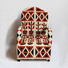 a red and black chair sitting on top of a white floor