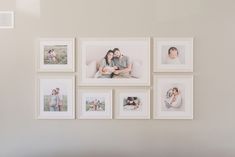 a white wall with multiple pictures hanging on it's side and a couch in the foreground