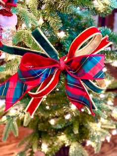 a christmas tree with red, blue and green bows