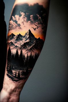 a man's arm with mountains and trees on it