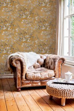 a chair and ottoman in front of a window