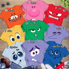 a group of t - shirts with different faces on them, all in different colors