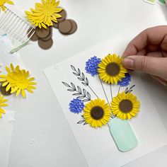 someone is making sunflowers out of paper