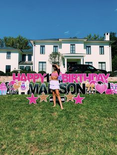 a woman standing in front of a birthday sign