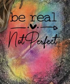 a woman wearing a t - shirt that says be real, not perfect on it