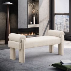 a white bench sitting in front of a window next to a book shelf and fireplace