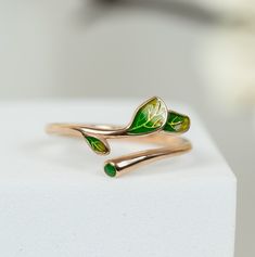 Minimalist rings for women can be a perfect gift for a birthday or a great gift for Christmas. Also, it can be a wonderful gift for grandma who likes nature. Our rings is handmade jewellery and we have three band colour options: silver, rose, and gold with three different colours of leaves. Inspired by nature, we are proud to offer this unique design emerald green olive tree branch rings.   📏 Adjustable size rings for women. No size problem!  It is made of 925 sterling silver and handmade Jewel Green Open Ring Jewelry For Gift, Nature-inspired Ring With May Birthstone For Gift, Nature-inspired Ring Jewelry For Gifts, Nature-inspired Ring Jewelry Gift, Dainty Green Rings For Gift, Rings For Mom, Olive Tree Branch, Branch Rings, Pink Rings