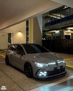 a silver car parked in front of a building