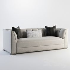 a white couch with black pillows on it