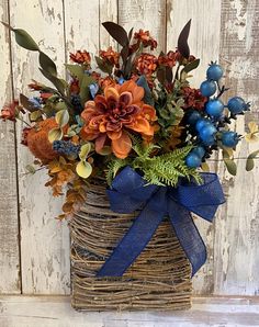 a basket filled with lots of flowers on top of a wooden table