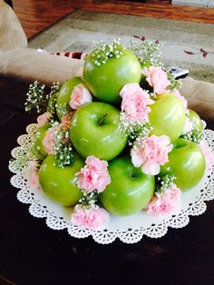 green apples with pink flowers on a doily