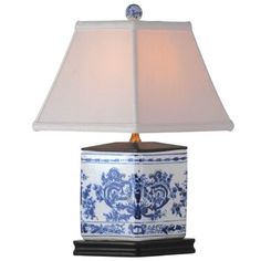 a blue and white lamp with a shade on it