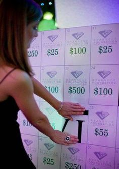 a woman standing in front of a wall with $ 250 on it's side