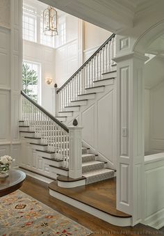 a white staircase leading up to the second floor