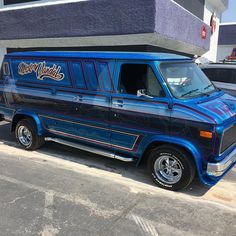 a blue van parked in front of a building