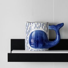 a blue whale mug sitting on top of a shelf