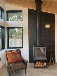 a living room filled with furniture and a fire place in front of a window covered wall