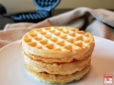 a stack of waffles sitting on top of a white plate