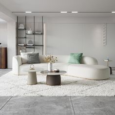 a living room filled with white furniture and lots of pillows on top of a rug