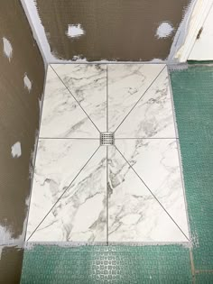 a tiled floor with white and green tiles