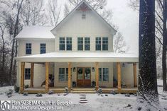 a large white house in the middle of winter with snow on the ground and trees around it