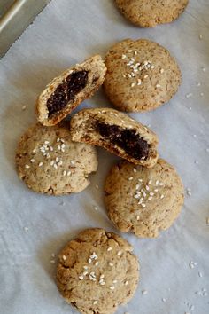 cookies with oatmeal and raisins sitting on top of parchment paper