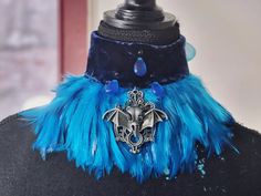 This unique choker is made of soft blue velvet and decorated with feathers, plastic beads, glass tears and metallic skull of a bird.  One size Height of choker - 5 cm. Length of velvet part - 35 cm Adjustable Blue Costume Accessories For Costume Party, Blue Fantasy Costume Accessories For Fantasy Events, Adjustable Blue Costume Accessories For Halloween, Blue Handmade Jewelry For Cosplay, Handmade Blue Jewelry For Cosplay, Adjustable Blue Costume Accessories For Cosplay, Glass Tears, Feather Accessories, Unique Choker