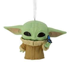 the child yoda ornament is hanging from a string