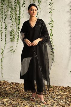 Black kurta with placement leaf embroidery and scalloped sheer panels. Paired with scalloped edge flared pant and sheer embroidered dupatta.
Components: 3
Pattern: Embroidered
Type Of Work: Nakshi, Zari, Cutdana
Neckline: Scallop
Sleeve Type: Scallop
Fabric: Kurta: Chanderi, Pant: Cotton Satin, Dupatta: Organza, Lining: Cotton
Color: Black
Other Details: 
Length:
Kurta: 45 inches
Pant: 37 inches
Dupatta (LXW): 90 X 20 inches
Occasion: Sangeet - Aza Fashions Black Kurta, Embroidered Pants, Straight Kurta, Organza Dupatta, Kurta With Pants, Kurta Designs, Kurta Set, Pants Pattern, Pant Set